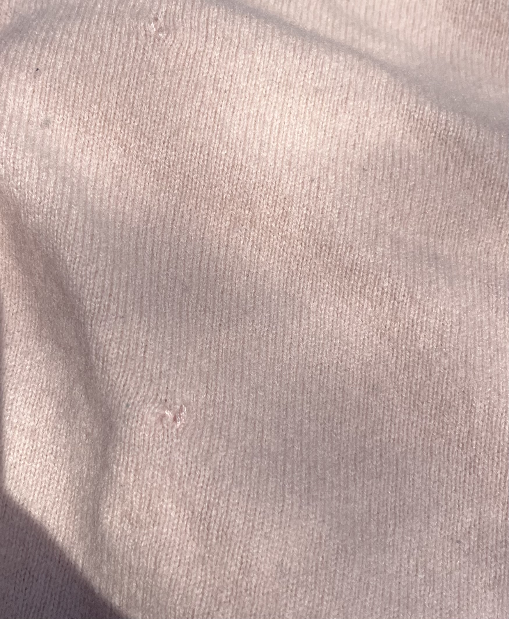 Close up of cardigan with small mends